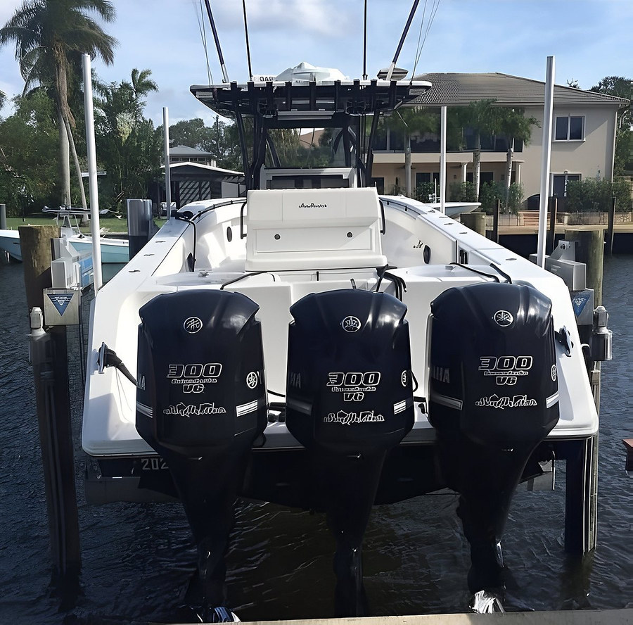 Center console on boat lift, rear view — South Florida canal by Contour Marine