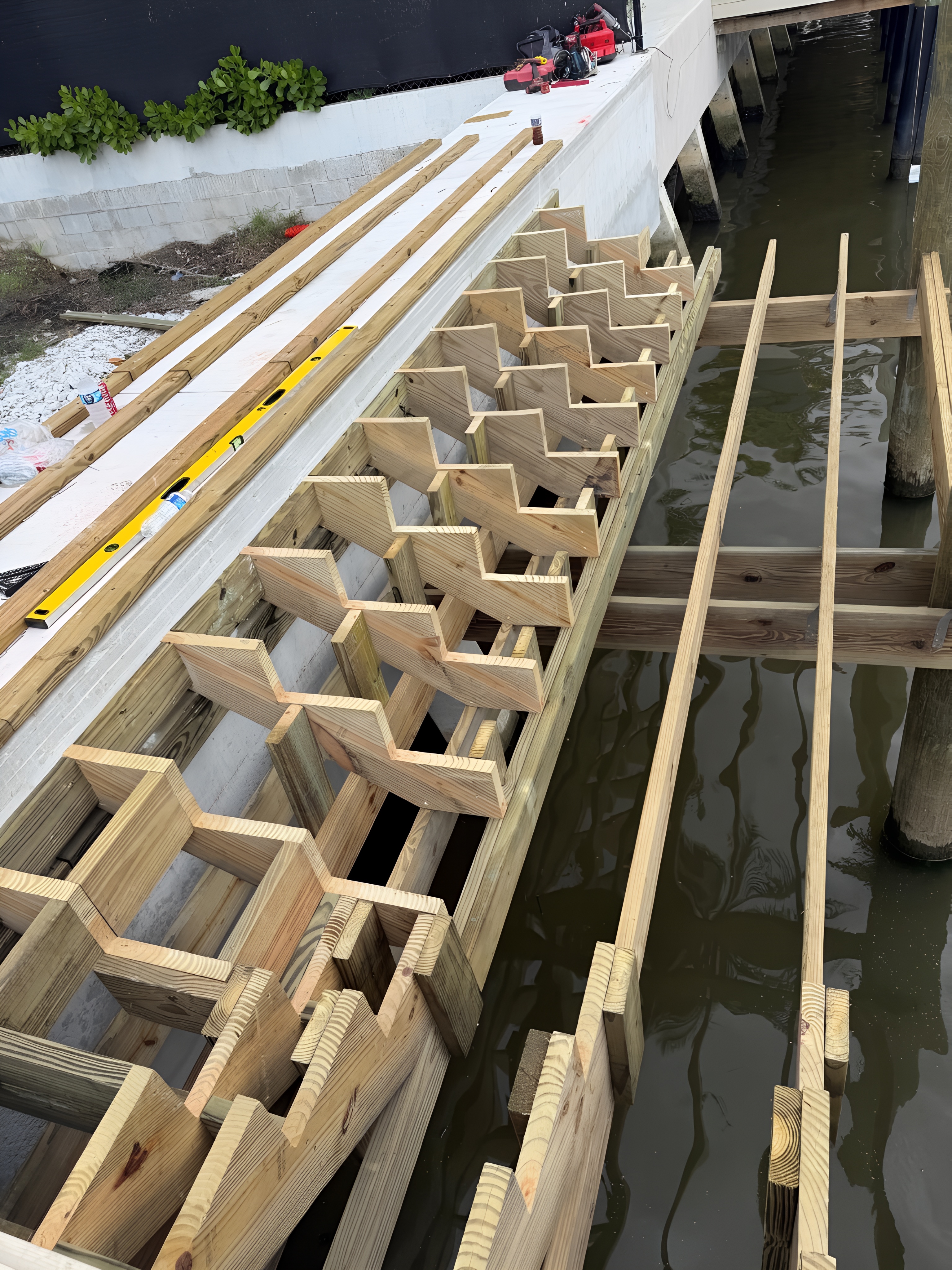 Structural framing and custom stair stringers during dock construction — Contour Marine South Florida